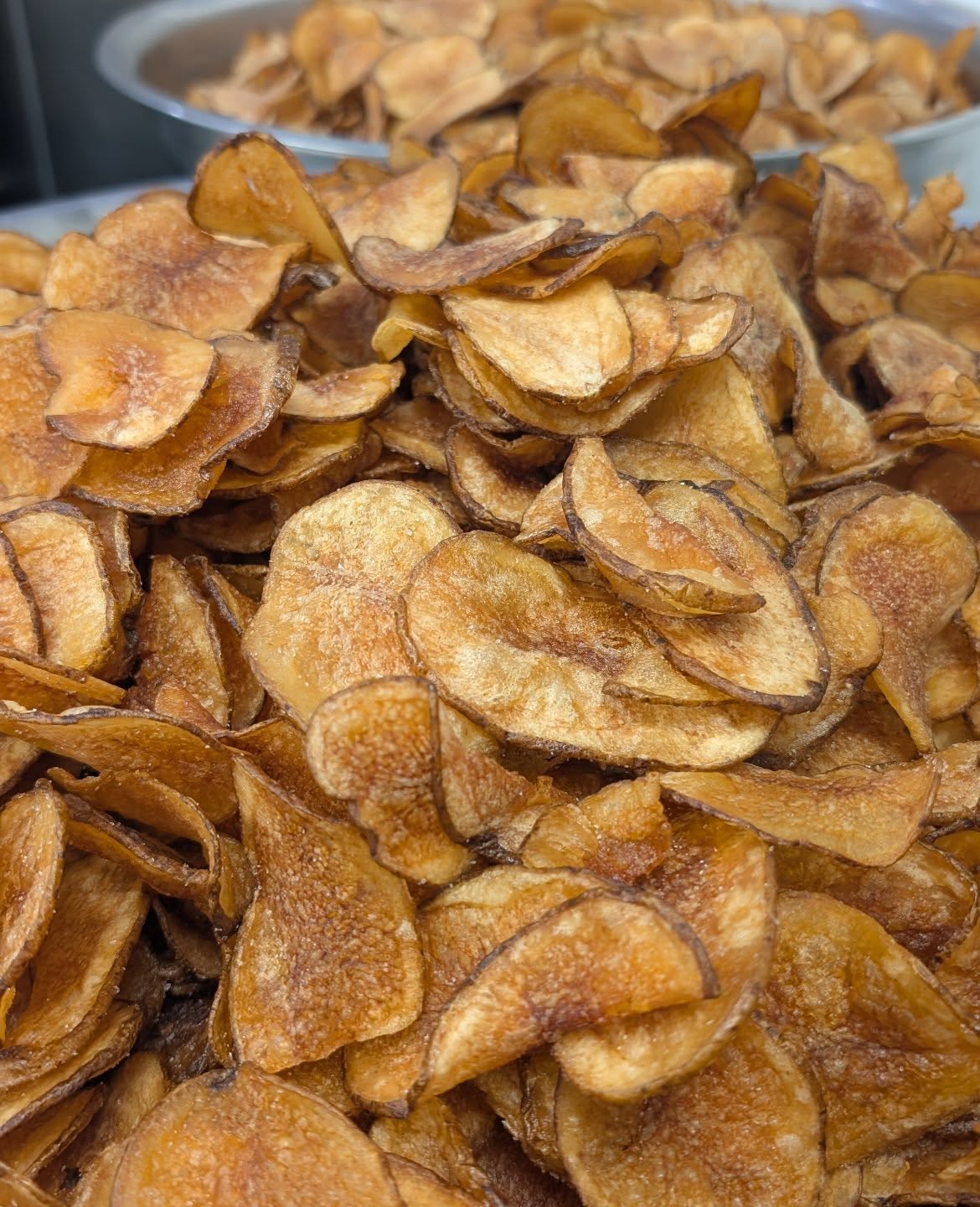 Extreme close-up of golden tallow-cooked FAT Chips potato chips